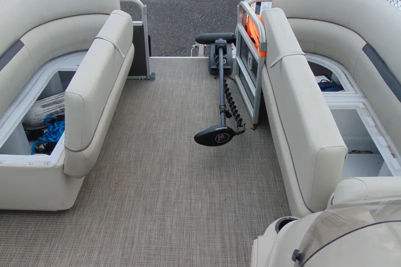 Slide: The Image of 2019 Godfrey SW 180C pontoon boat interior with seating and storage compartments. - 18