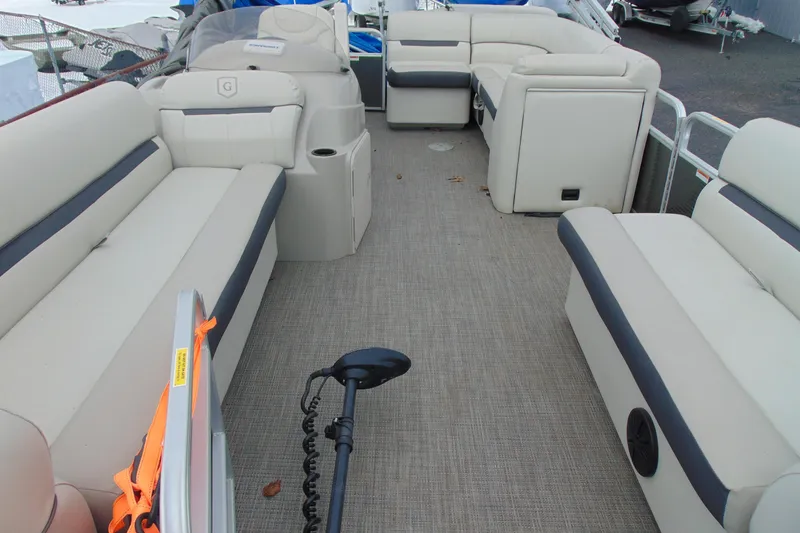Slide: The Image of 2019 Godfrey SW 180C pontoon boat interior with beige seating and carpeted floor. - 7