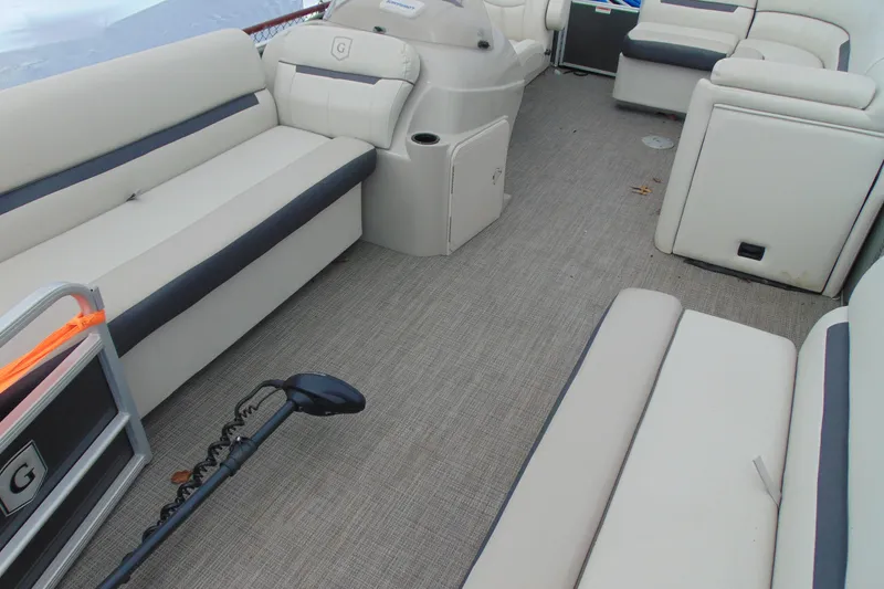 Slide: The Image of 2019 Godfrey SW 180C pontoon boat interior with beige seating and gray flooring. - 8