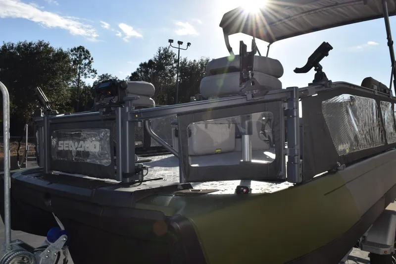 Slide: The Image of 2026 Sea-Doo Switch Fish 21 pontoon boat with fishing setup in sunlight. - 4