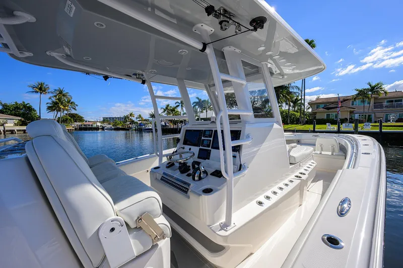 Slide: The Image of 2021 Invincible 39 Open Fisherman boat interior with helm, seats, and water view. - 22