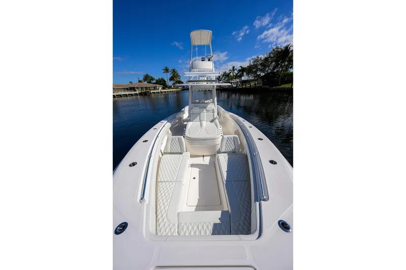 Slide: The Image of 2021 Invincible 39 Open Fisherman boat on calm water, featuring spacious deck and seating. - 36