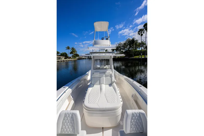 Slide: The Image of 2021 Invincible 39 Open Fisherman boat on calm water under blue sky. - 39