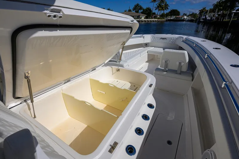 Slide: The Image of 2021 Invincible 39 Open Fisherman boat with open storage compartment, dockside view. - 43