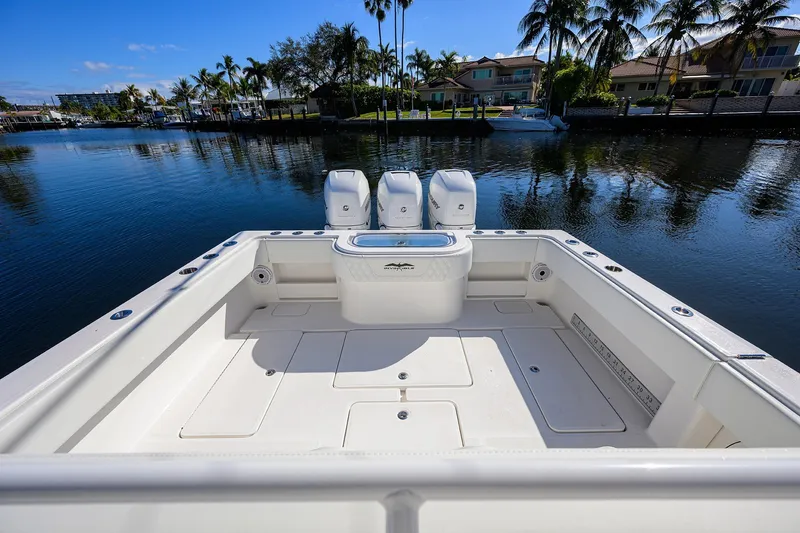 Slide: The Image of 2021 Invincible 39 Open Fisherman boat with triple engines on a serene waterfront. - 48