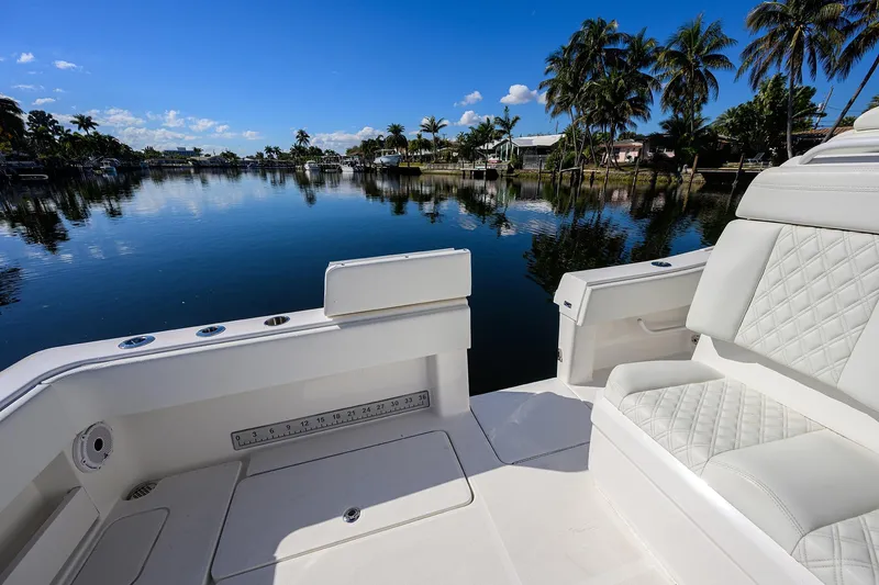 Slide: The Image of 2021 Invincible 39 Open Fisherman boat on calm water with palm trees. - 60