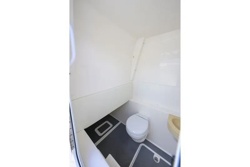 Slide: The Image of 2021 Invincible 39 Open Fisherman boat interior bathroom with toilet and sink. - 63