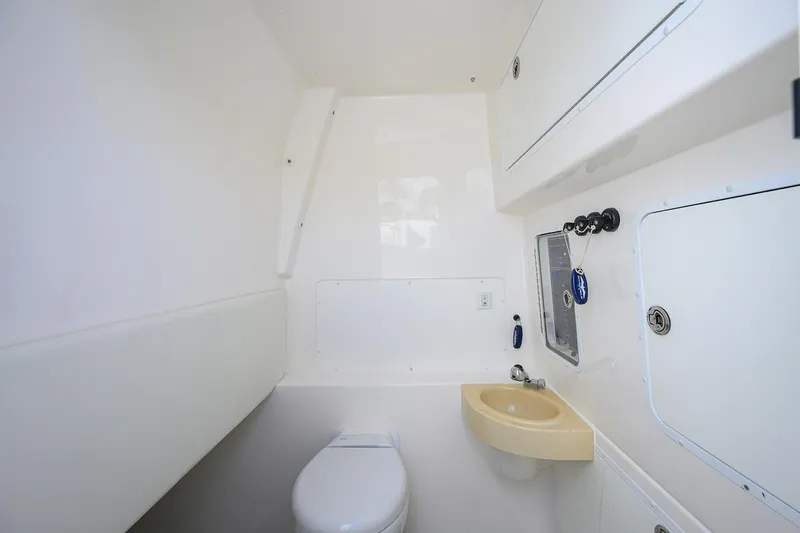 Slide: The Image of 2021 Invincible 39 Open Fisherman boat bathroom with toilet and sink. - 65