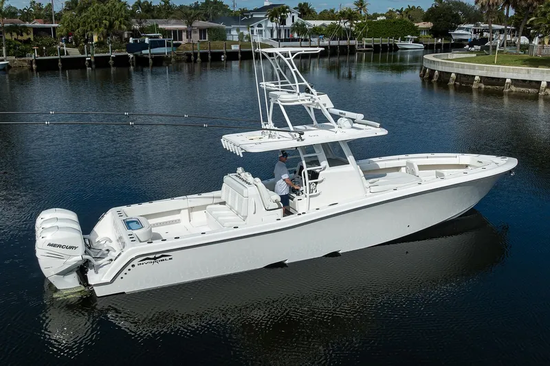 Slide: The Image of 2021 Invincible 39 Open Fisherman boat on calm water, featuring dual Mercury engines. - 7