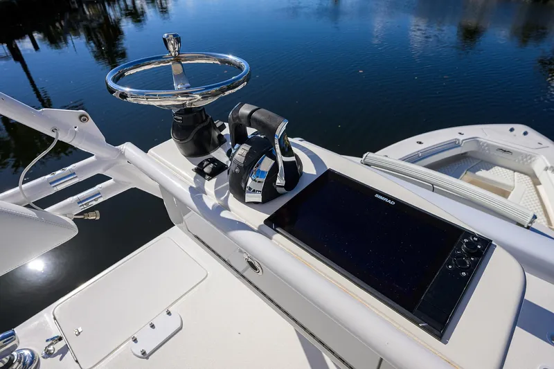 Slide: The Image of 2021 Invincible 39 Open Fisherman helm with steering wheel and navigation display. - 85