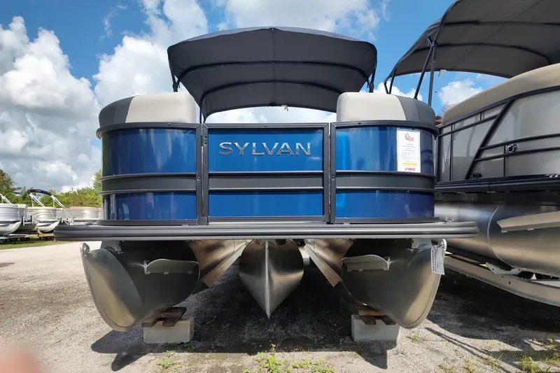 The Image of 2026 Sylvan L3 DLZ pontoon boat with blue exterior, parked outdoors under a cloudy sky. - 0
