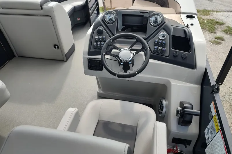 Slide: The Image of 2026 Sylvan L3 DLZ boat cockpit with modern steering and control panel. - 2