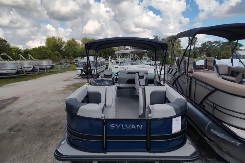 Slide: The Image of 2026 Sylvan L3 DLZ boat interior with modern seating and steering wheel. - 9