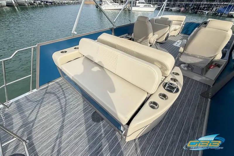 Slide: The Image of 2021 Premier 230 Sunsation RL PTX pontoon boat interior with beige seating and cup holders. - 21