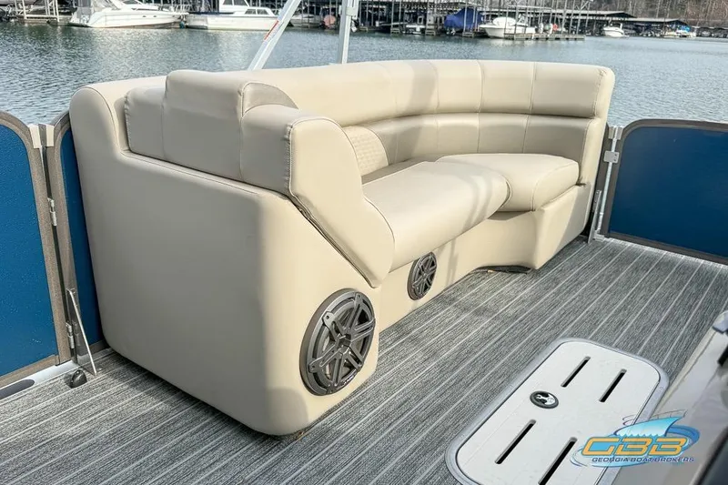 Slide: The Image of 2021 Premier 230 Sunsation RL PTX boat interior with beige seating and speaker system. - 25