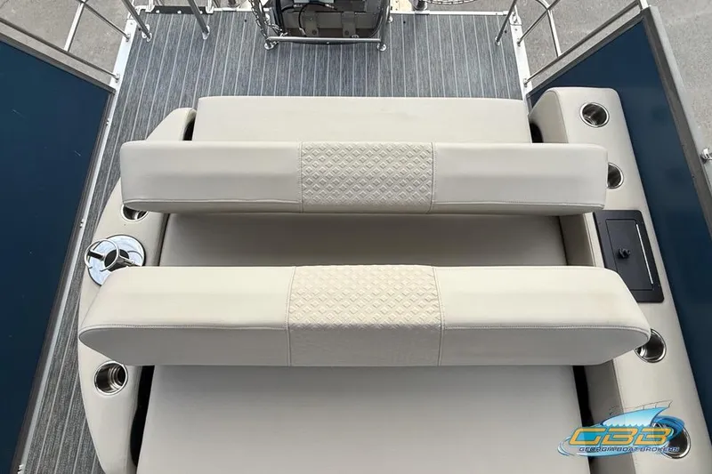 Slide: The Image of 2021 Premier 230 Sunsation RL PTX boat interior with beige seating and cup holders. - 30