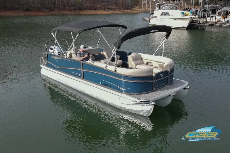 Slide: The Image of 2021 Premier 230 Sunsation RL PTX pontoon boat on a calm lake. - 4