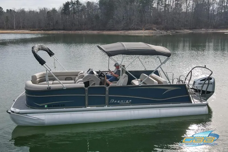 Slide: The Image of 2021 Premier 230 Sunsation RL PTX pontoon boat on a calm lake. - 5
