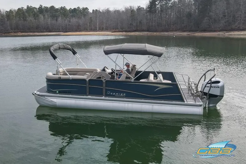 Slide: The Image of 2021 Premier 230 Sunsation RL PTX pontoon boat on a calm lake. - 6