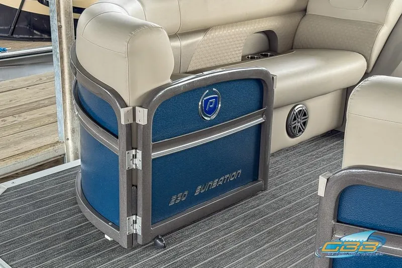 Slide: The Image of 2021 Premier 230 Sunsation RL PTX boat interior with beige seating and blue accents. - 7