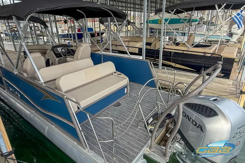 Slide: The Image of 2021 Premier 230 Sunsation RL PTX pontoon boat with Honda outboard motor in marina. - 9