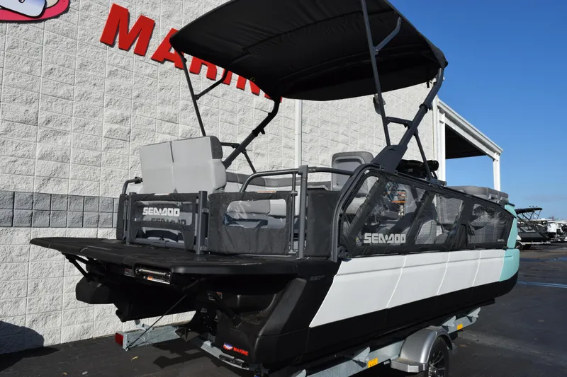 Slide: The Image of 2026 Sea-Doo Switch Cruise 21 pontoon boat with canopy, displayed at a marine dealership. - 4