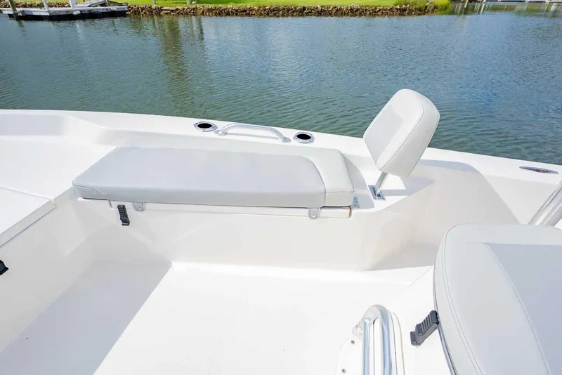Slide: The Image of 2026 Bay Rider 219 Bay boat interior with cushioned seating by the water. - 12