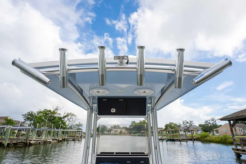 Slide: The Image of Bay Rider 219 Bay 2026 boat with rod holders, docked under a blue sky. - 22