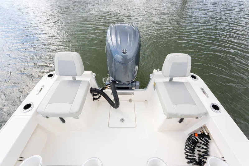 Slide: The Image of Manufacturer Provided Image: 2025 Bay Rider 219 Bay boat with dual seats and outboard motor on water. - 23