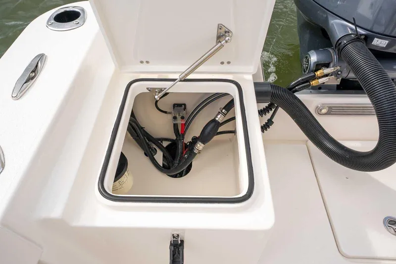 Slide: The Image of 2026 Bay Rider 219 Bay boat compartment with engine connections and hoses. - 32