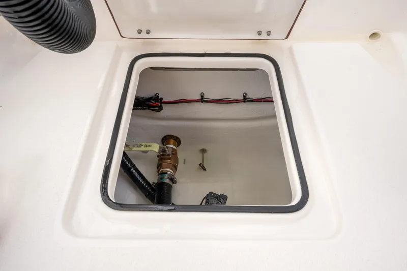 Slide: The Image of Open hatch of 2026 Bay Rider 219 Bay boat showing internal wiring and plumbing. - 34