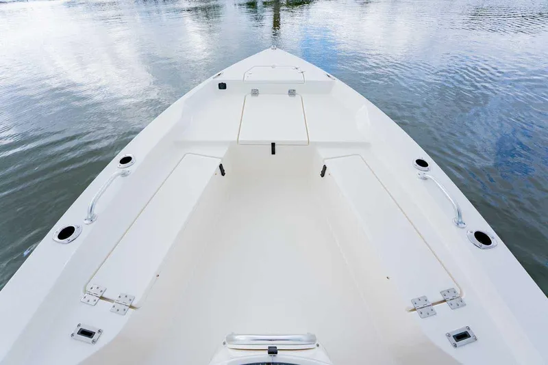 Slide: The Image of Manufacturer Provided Image: 2025 Bay Rider 219 Bay boat interior, showcasing spacious deck and sleek design on calm water. - 6