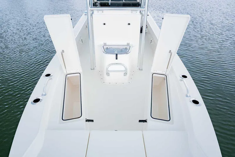 Slide: The Image of Manufacturer Provided Image: 2025 Bay Rider 219 Bay boat interior with open storage compartments on calm water. - 7