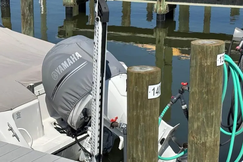 Slide: The Image of 2023 Edgewater 248CX Crossover boat on calm ocean waters. - 2