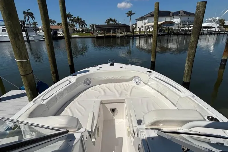 Slide: The Image of 2023 Edgewater 248CX Crossover boat on calm water under clear blue sky. - 3