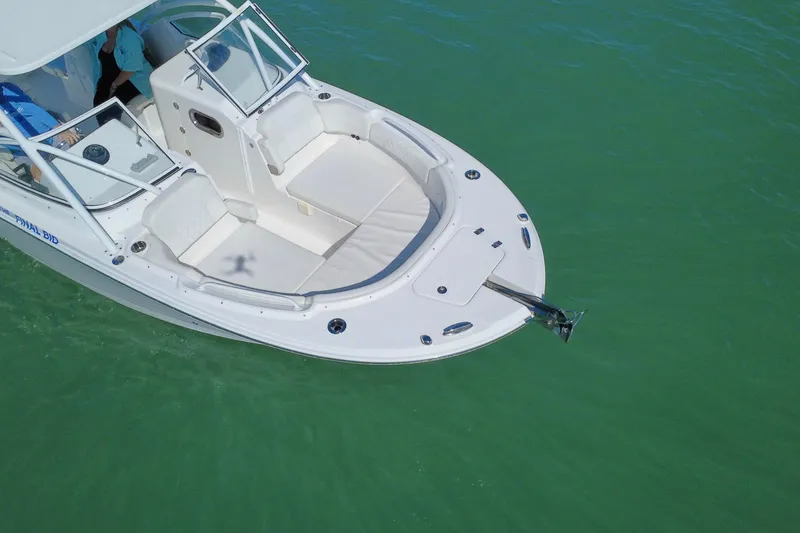 Slide: The Image of 2023 Edgewater 248CX Crossover boat on calm blue water, side view. - 31