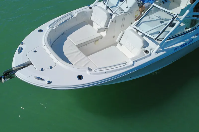 Slide: The Image of 2023 Edgewater 248CX Crossover boat on calm blue water with clear sky. - 32