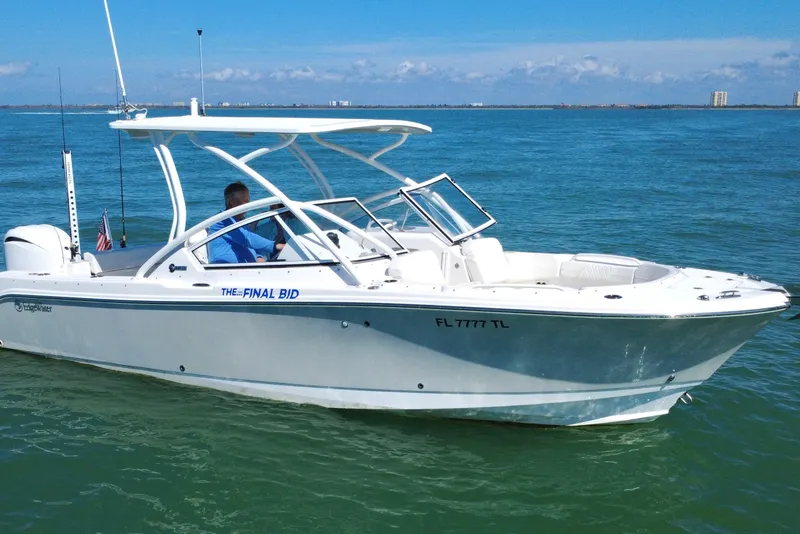 Slide: The Image of 2023 Edgewater 248CX Crossover boat cruising on clear blue water. - 33