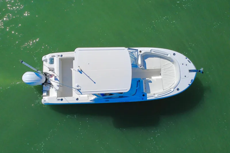 Slide: The Image of 2023 Edgewater 248CX Crossover boat cruising on calm blue waters. - 38