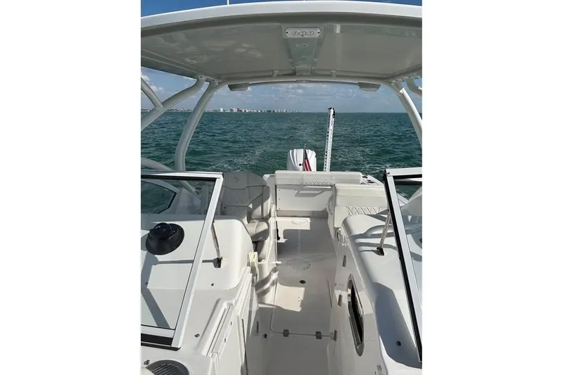 Slide: The Image of 2023 Edgewater 248CX Crossover boat on calm water, featuring sleek design and modern amenities. - 4