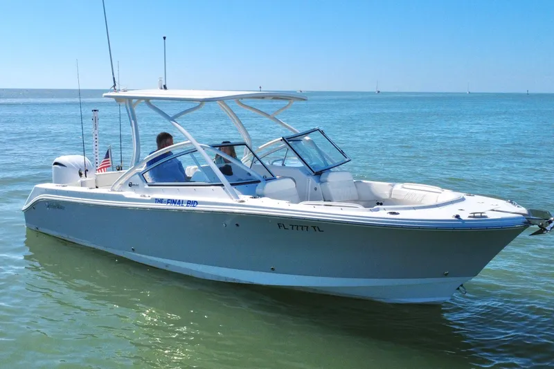Slide: The Image of 2023 Edgewater 248CX Crossover boat cruising on calm blue waters. - 41