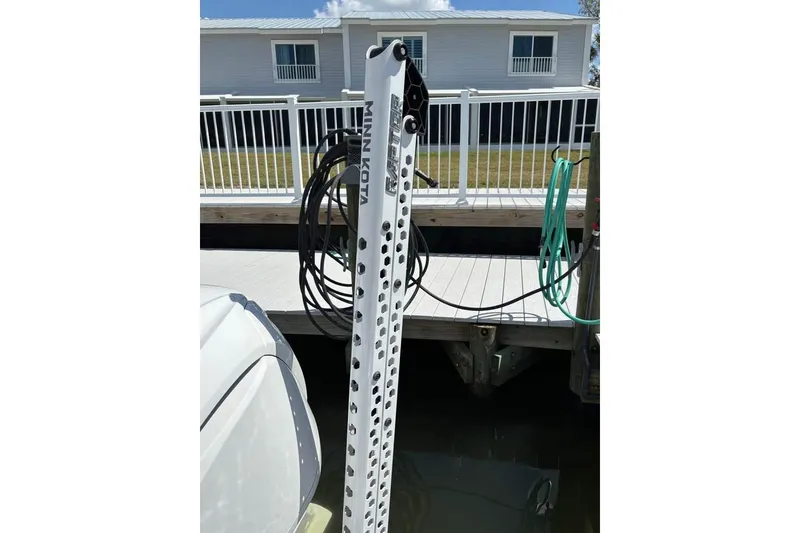 Slide: The Image of 2023 Edgewater 248CX Crossover boat docked with Yamaha engine cover. - 7