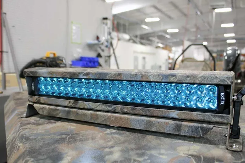 Slide: The Image of Blue LED light bar on Excel Switchblade 2026, camo design, in industrial setting. - 17