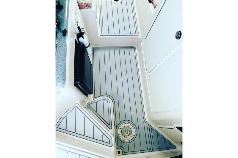 Slide: The Image of 1996 Pro-Line 2950 Walkaround boat deck with sleek, modern design and storage compartments. - 12