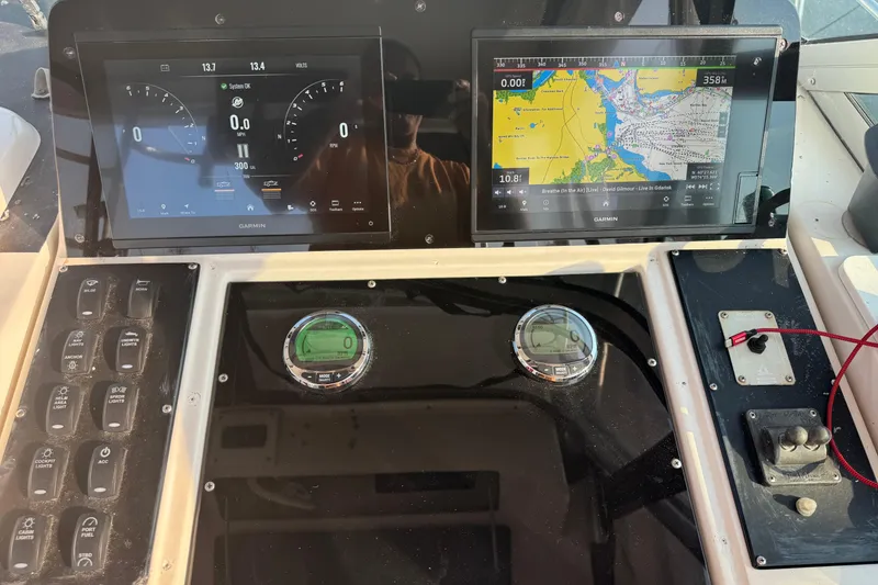 Slide: The Image of 1996 Pro-Line 2950 Walkaround dashboard with Garmin navigation displays and control panel. - 14