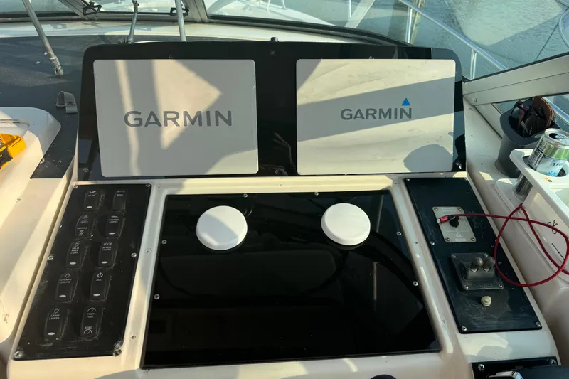 Slide: The Image of 1996 Pro-Line 2950 Walkaround boat dashboard with dual Garmin displays and control panel. - 15