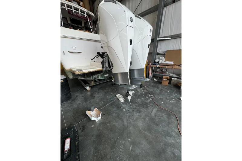 Slide: The Image of 1996 Pro-Line 2950 Walkaround boat with dual outboard motors in a garage setting. - 19