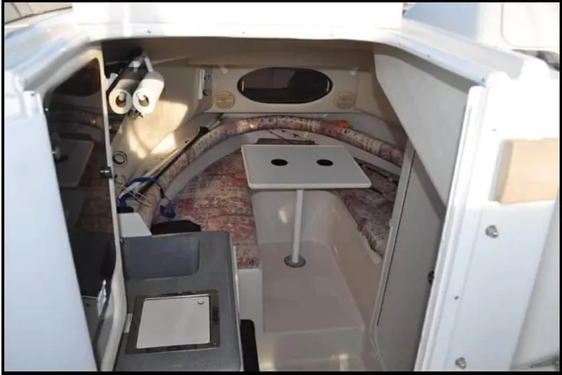 Slide: The Image of 1996 Pro-Line 2950 Walkaround boat with twin Evinrude 250 engines docked at marina. - 2