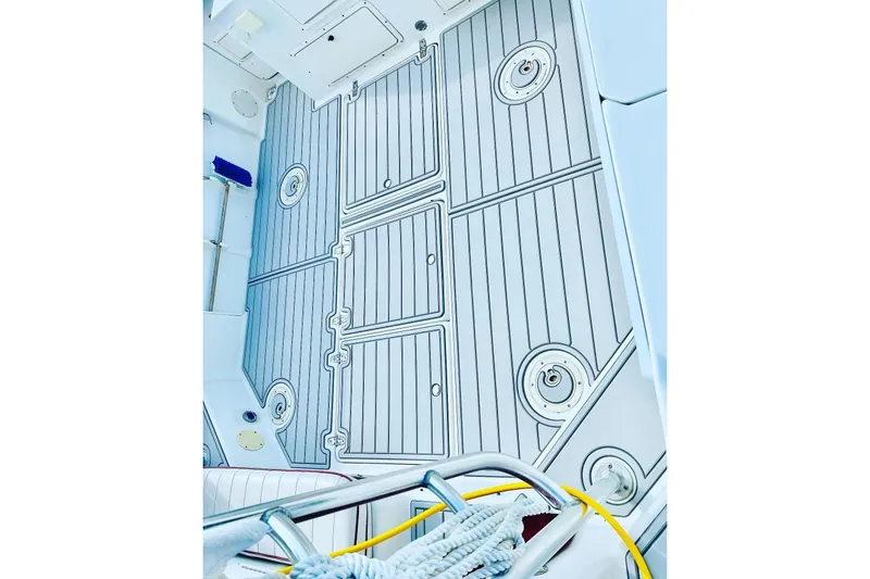 Slide: The Image of 1996 Pro-Line 2950 Walkaround boat deck with storage hatches and marine equipment. - 5