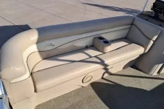 Slide: The Image of 2014 BENNIGTON S21 boat seating with beige upholstery and built-in cup holder. - 11